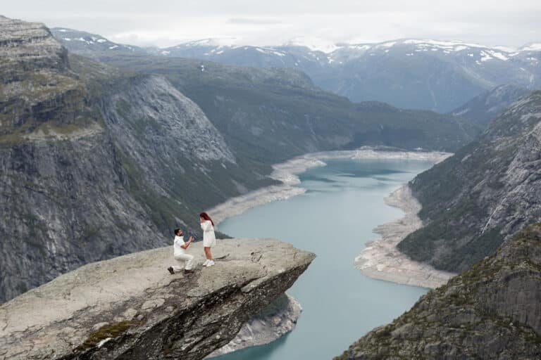 A man proposing to a trolltunga