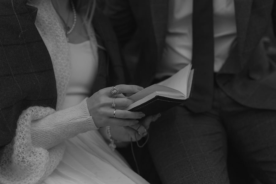 Close-up on the bride's hands as she reads her vows