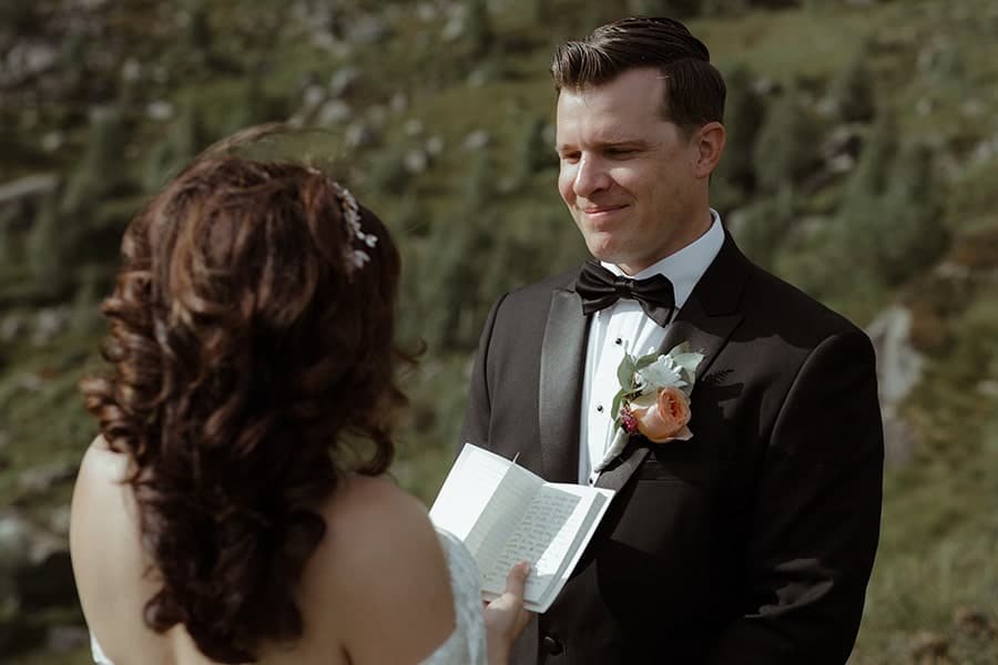 non-traditional wedding with a bride reading her vows in nature